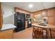 Cozy kitchen with wood cabinets, black appliances, and an eat-in dining area at 6017 Chestatee Creek Nw Ct, Acworth, GA 30101