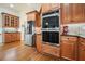 Kitchen area featuring stainless steel double ovens, refrigerator and hardwood flooring at 6017 Chestatee Creek Nw Ct, Acworth, GA 30101