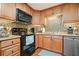 Updated kitchen featuring wood cabinets, stainless steel dishwasher, and tiled backsplash at 6017 Chestatee Creek Nw Ct, Acworth, GA 30101