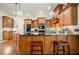Kitchen island with granite countertops and bar seating, alongside stainless steel appliances at 6017 Chestatee Creek Nw Ct, Acworth, GA 30101