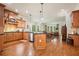 Spacious kitchen with stainless steel appliances, wooden cabinets, hardwood floors, and an island at 6017 Chestatee Creek Nw Ct, Acworth, GA 30101