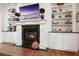 Cozy living room featuring a fireplace with built-in shelves for storage and display, creating a warm and inviting atmosphere at 6017 Chestatee Creek Nw Ct, Acworth, GA 30101