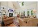 Inviting living room with high ceilings, built-in shelves, a fireplace, and an abundance of natural light for relaxed living at 6017 Chestatee Creek Nw Ct, Acworth, GA 30101