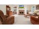 Spacious living room with a stone fireplace, built-in shelving, and ample seating at 6017 Chestatee Creek Nw Ct, Acworth, GA 30101