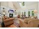 Bright living room with hardwood floors, fireplace, vaulted ceilings, and lots of natural light at 6017 Chestatee Creek Nw Ct, Acworth, GA 30101