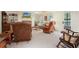 Spacious living room with a stone fireplace, built-in shelving, and comfortable seating arrangement at 6017 Chestatee Creek Nw Ct, Acworth, GA 30101