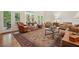 Elegant living room with a large rug, comfortable seating, and glass doors leading to the outside at 6017 Chestatee Creek Nw Ct, Acworth, GA 30101
