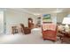 Bright living room features a fireplace and built-in shelving, with plenty of seating at 6017 Chestatee Creek Nw Ct, Acworth, GA 30101