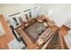 A bright, high-ceilinged living room features hardwood floors, a ceiling fan, multiple chairs, and a large area rug at 6017 Chestatee Creek Nw Ct, Acworth, GA 30101
