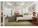 Bright main bedroom featuring a bed, sitting area, and windows at 6017 Chestatee Creek Nw Ct, Acworth, GA 30101