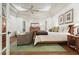 Elegant main bedroom showcasing hardwood floors, a tray ceiling, and views of the outdoors at 6017 Chestatee Creek Nw Ct, Acworth, GA 30101