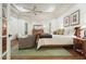 Bright main bedroom with tray ceilings, hardwood floors, and a queen bed at 6017 Chestatee Creek Nw Ct, Acworth, GA 30101