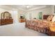 Spacious main bedroom with tray ceilings, a ceiling fan, large dressers, and an exterior door to balcony at 6017 Chestatee Creek Nw Ct, Acworth, GA 30101