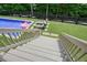 View from deck stairs leading to a refreshing pool and backyard retreat at 6017 Chestatee Creek Nw Ct, Acworth, GA 30101