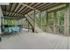 Spacious screened porch with outdoor dining area, staircase, and wooded views at 6017 Chestatee Creek Nw Ct, Acworth, GA 30101