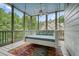 Inviting screened porch featuring a daybed swing at 6017 Chestatee Creek Nw Ct, Acworth, GA 30101