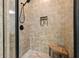 The tiled shower features a built-in shelf and a comfortable wooden bench, making it a luxurious experience at 6017 Chestatee Creek Nw Ct, Acworth, GA 30101