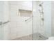 Close-up of a newly tiled shower with safety bars and decorative accents at 6017 Chestatee Creek Nw Ct, Acworth, GA 30101