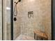 Modern tiled shower with glass door and bench at 6017 Chestatee Creek Nw Ct, Acworth, GA 30101