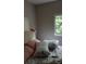 A cozy bedroom featuring a comfortable bed with soft pillows and natural light streaming through the window at 80 Place Fontaine, Lithonia, GA 30038