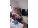 Bedroom featuring a rack of clothing, television, and a variety of personal items at 80 Place Fontaine, Lithonia, GA 30038