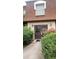 Charming exterior with a well-maintained entrance featuring a brown door and lush green shrubs at 80 Place Fontaine, Lithonia, GA 30038