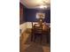 Inviting dining room featuring chair rail detail, dark wood furniture, and a colorful painting on the wall at 80 Place Fontaine, Lithonia, GA 30038