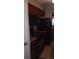 Efficient kitchen with dark wood cabinets, modern appliances, and a connected dining area at 80 Place Fontaine, Lithonia, GA 30038