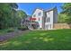 A lush green backyard has mature trees and a deck at 1875 Edgemont Ct, Cumming, GA 30041