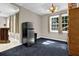Spacious basement area features a refrigerator, dark blue carpet and natural light from the windows at 1875 Edgemont Ct, Cumming, GA 30041