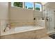 Bright bathroom showcasing a soaking tub and glass shower at 1875 Edgemont Ct, Cumming, GA 30041
