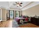 A cozy bedroom features a ceiling fan, hardwood floors, and two windows at 1875 Edgemont Ct, Cumming, GA 30041