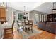 Bright dining area with a chandelier, wood floors, and large windows overlooking the yard at 1875 Edgemont Ct, Cumming, GA 30041