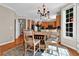 Sun-lit dining area featuring a wooden table, with a view into the kitchen with granite countertops at 1875 Edgemont Ct, Cumming, GA 30041
