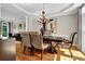 Formal dining room with hardwood floors, elegant lighting, and stylish decor at 1875 Edgemont Ct, Cumming, GA 30041