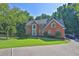 Charming two-story brick home with a manicured lawn and lush landscaping at 1875 Edgemont Ct, Cumming, GA 30041