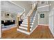 Inviting foyer with hardwood floors, staircase with iron railing, and elegant decor at 1875 Edgemont Ct, Cumming, GA 30041