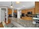 Modern kitchen with granite countertops, stainless steel appliances, and wood cabinetry at 1875 Edgemont Ct, Cumming, GA 30041