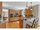 Well-lit kitchen featuring wooden cabinets, stainless steel appliances, and an adjoining dining area at 1875 Edgemont Ct, Cumming, GA 30041