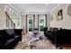 Sophisticated living room featuring stylish furniture and large arched windows at 1875 Edgemont Ct, Cumming, GA 30041