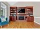 Comfortable living area with built-in bookshelves and a fireplace, perfect for relaxation at 1875 Edgemont Ct, Cumming, GA 30041