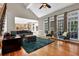 Spacious living room with hardwood floors, large windows, and an adjoining kitchen and dining area at 1875 Edgemont Ct, Cumming, GA 30041