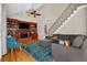 Cozy living room with a vaulted ceiling, built-in bookshelves, fireplace, and hardwood floors at 1875 Edgemont Ct, Cumming, GA 30041