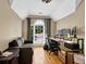 A home office features hardwood floors, natural light, and a work space at 1875 Edgemont Ct, Cumming, GA 30041