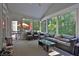 A sunny screened porch with wicker furniture provides extra space to relax at 1875 Edgemont Ct, Cumming, GA 30041