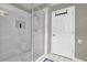 Bright shower room with white tile, glass door, overhead lighting, and a modern shower head at 1875 Edgemont Ct, Cumming, GA 30041