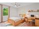 Bright bedroom features a ceiling fan, a large window with a wooded view, and stylish decor at 3119 Medley Rdg, Decatur, GA 30033