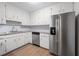 Modern kitchen featuring white cabinetry, granite countertops, stainless steel appliances, and tile backsplash at 3119 Medley Rdg, Decatur, GA 30033