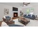 Cozy living room featuring a brick fireplace, ceiling fan, neutral color scheme, and bright windows at 3119 Medley Rdg, Decatur, GA 30033