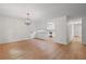 Open-concept living room with bright, neutral walls and elegant light wood flooring leading to other rooms at 3119 Medley Rdg, Decatur, GA 30033